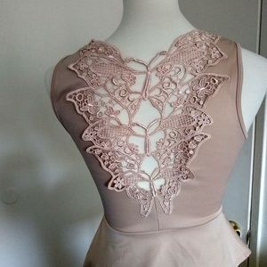 A nude  sleeveless peplum  top